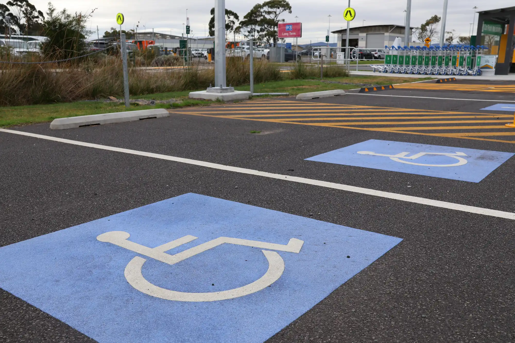 A designated disabled parking spot, located next to footpaths